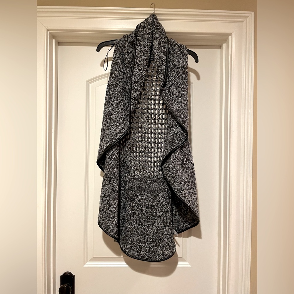 Gray stylish long eyelet sweater vest. Oval crocheted back adds to look!